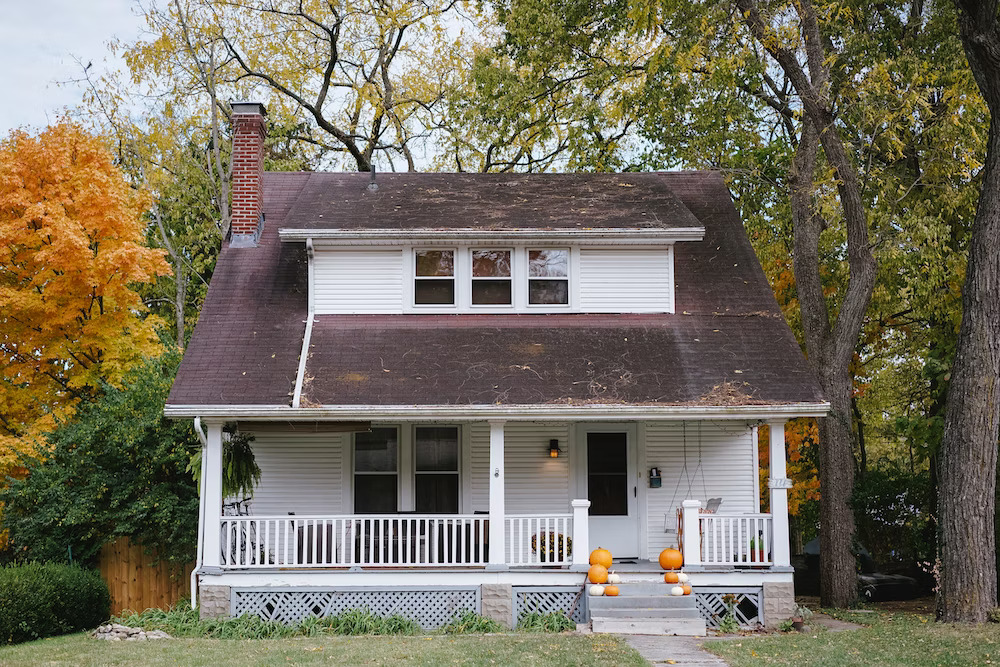 a white house surrounded by trees