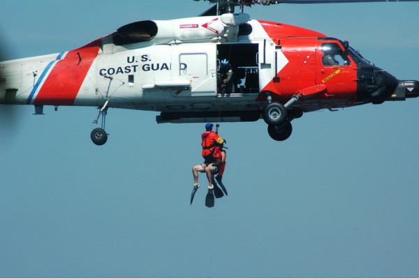 A U.S. Coast Guard helicopter performing a rescue operation.