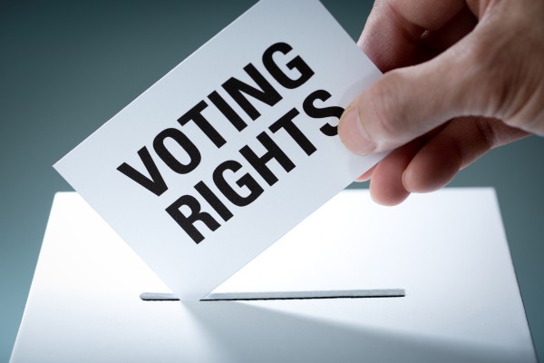 Card with “Voting Rights” inserted in ballot box.