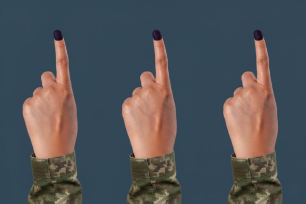 Military hands raised showing inked voting fingers.