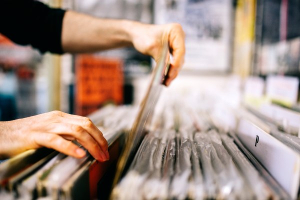 Person searching through organized folders and files in a record archive.